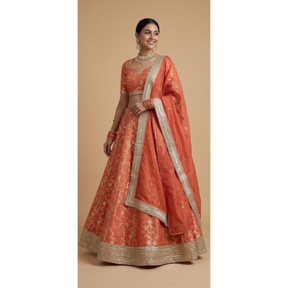 Woman wearing a traditional orange and gold embroidered outfit on a beige background