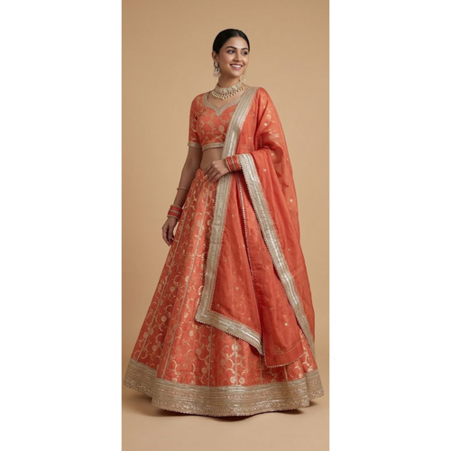 Woman wearing a traditional orange and gold embroidered outfit on a beige background