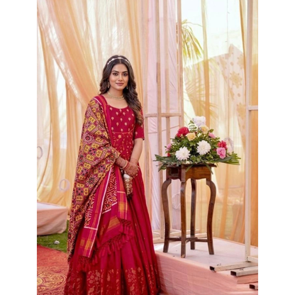 Woman in a red traditional outfit standing in a studio