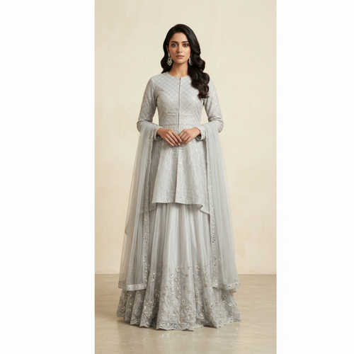 Woman wearing a silver embroidered traditional outfit on a beige background